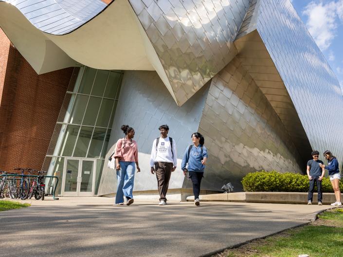 Students walk together away from the Weatherhead building.