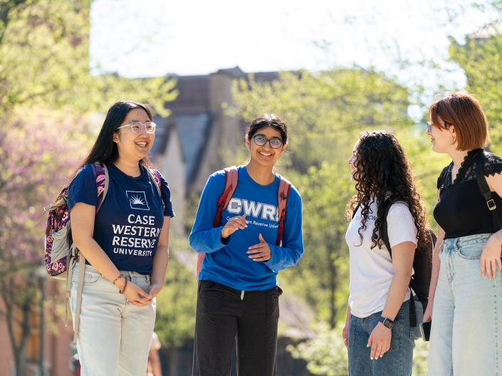 Group of CWRU students talking on campus.