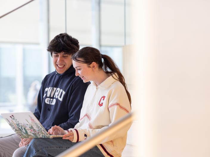 Two students looking at a laptop.