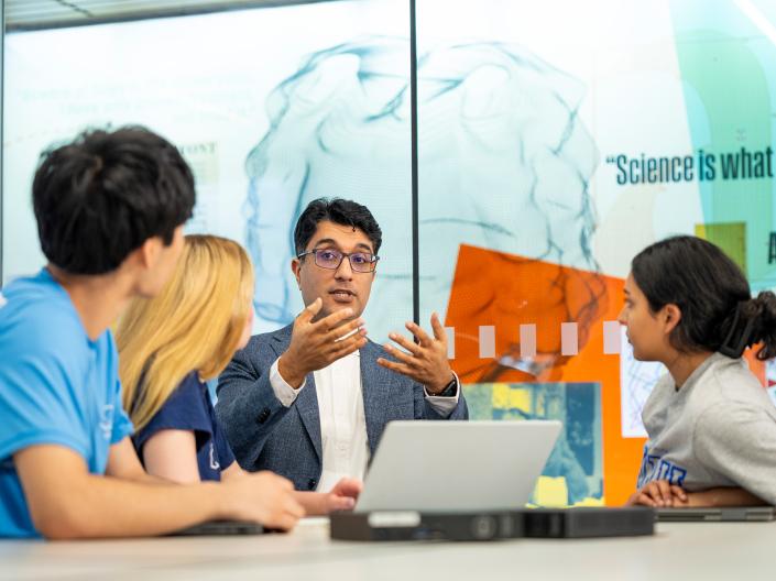 Professor talking to students.