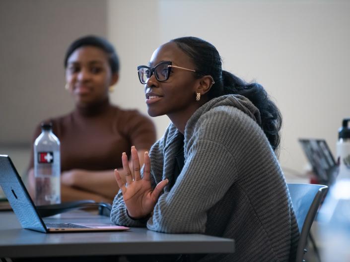 Students talk and participate during a class lecture.