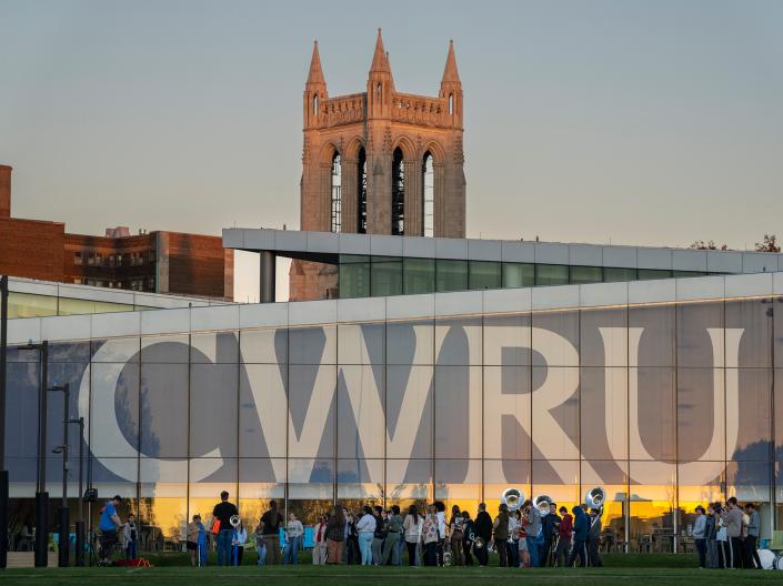 Students mingle underneath the CWRU banner on the Tinkham Veale University Center.