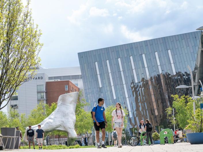 Two students walking near campus.