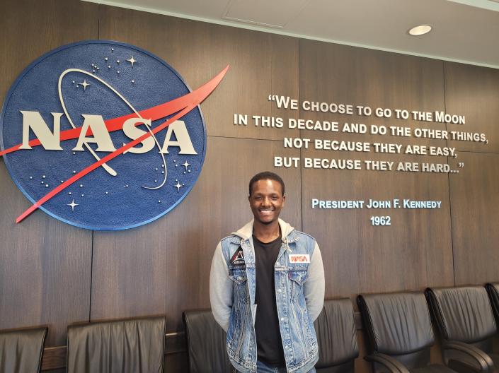 Student in front of NASA sign
