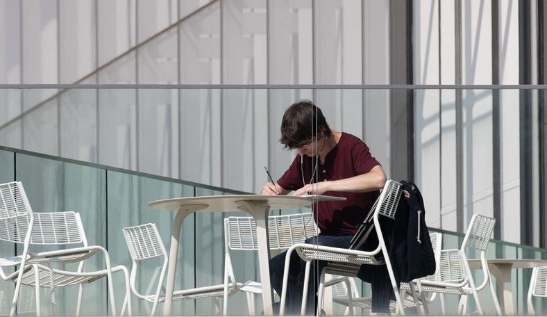 Student studying on a balcony 