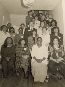 A large group of African American Alumni Association members poses for a photo (black and white)