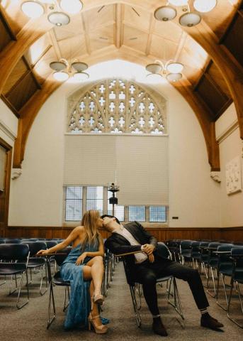 Irina Yakubenko and Scho Wolers lean across their desks in Clark Hall to kiss