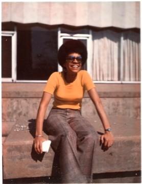 Joannie Brooks Parker smiles wearing sunglasses at Wade Commons in 1970