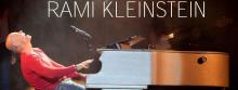 Photo of Israeli Popstar Rami Kleinstein playing piano on stage