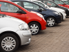 Multiple cars, in a line in a parking lot