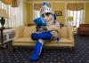 CWRU mascot Sparty the Spartan sitting on a couch in the Linsalata Alumni Center reading Think Magazine