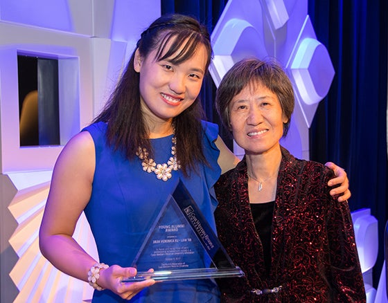 CWRU Alumna Veronica Xu poses with her mother and The Alumni Association's 2017 Young Alumni Award during Homecoming 2017.