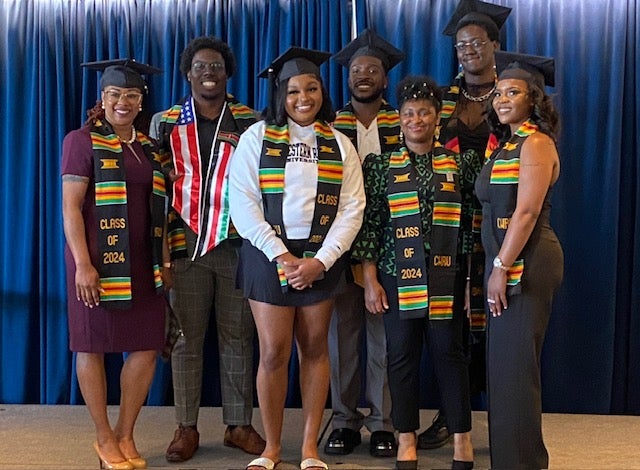 Students smile for camera celebrating Black Graduation