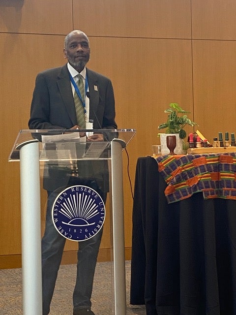 John W. Patton, Jr. Esq. speaks at podium, wearing formal attire