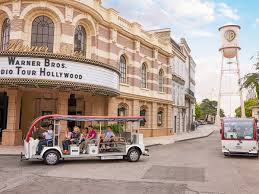 Warner Bros. tour tram passes by theater