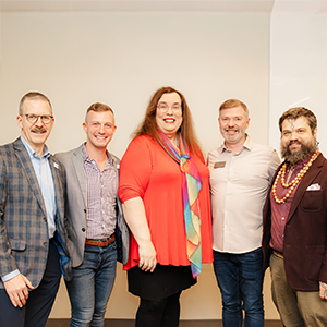 CWRU Pride: The LGBT Alumni Network group members smile at camera while wearing casual and formal attire