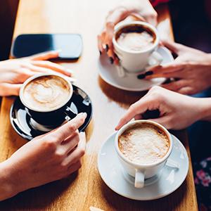 People sitting around talking over coffee