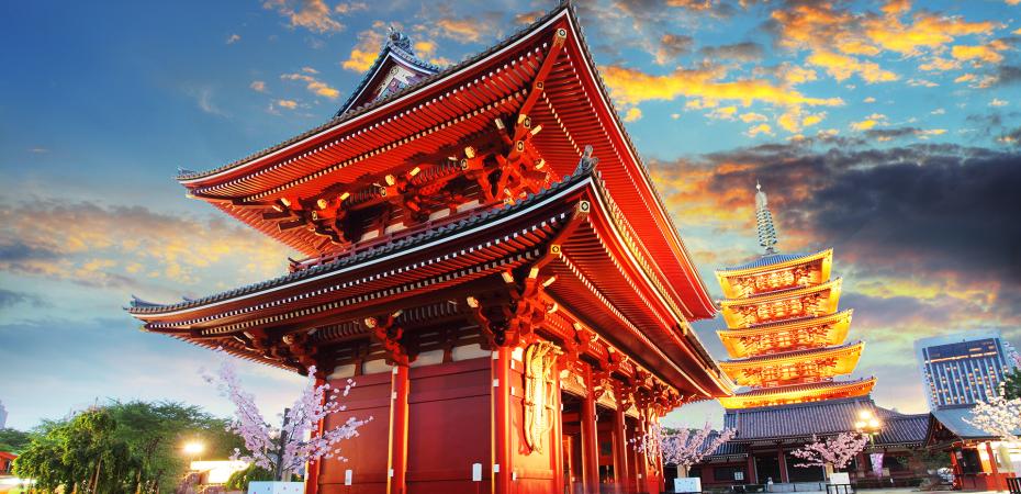A traditional Japanese building shown in the evening, illuminated