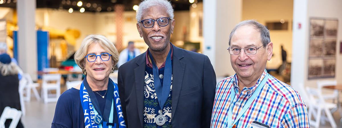 Three CWRU alumni celebrating at an event
