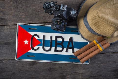 image of Cuba license plate, cigars, hat and camera