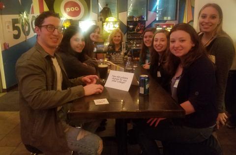 A group of students sitting at a table at a Jewish Alumni Network event