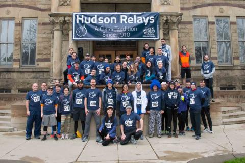Photo of 2018 Alumni Hudson Relays team posed and smiling in front of Adelbert Hall