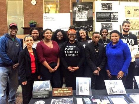 African American Alumni Association members pose with a display contributed to the Mobile Black History Museum that visited the CWRU campus.