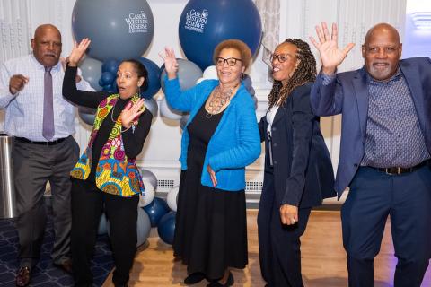 WRC ’75 graduates, David Smith, Erma Leaphart-Gouch, Marilyn Maultsby, Joanne Brogdon and Mark Smith “raise the roof” in front of gray and blue CWRU balloons