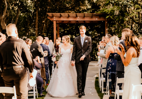 Julia and Utah Moffett walk down the aisle at the end of their wedding ceremony