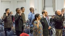A group of people take the oath of citizenship to the United States