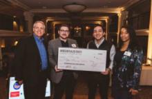 Team members at Case Western Reserve University startup competition pose with an oversized check