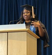 Sydney Lloyd speaking at podium