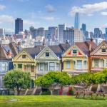 Row houses in front of the San Francisco city skyline as shown in the daytime
