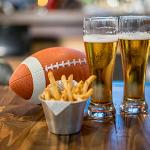 Football sitting on a bar alongside drinks and food