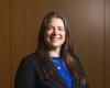 Alexandra Balzer smiles at camera while wearing formal attire