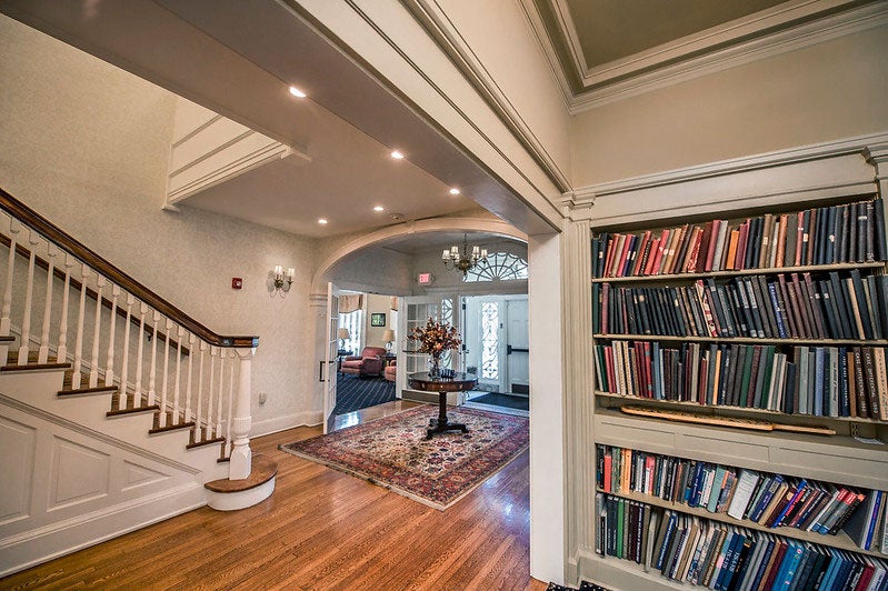 The first floor of the Linsalata Alumni Center between the stairwell and the bookshelf