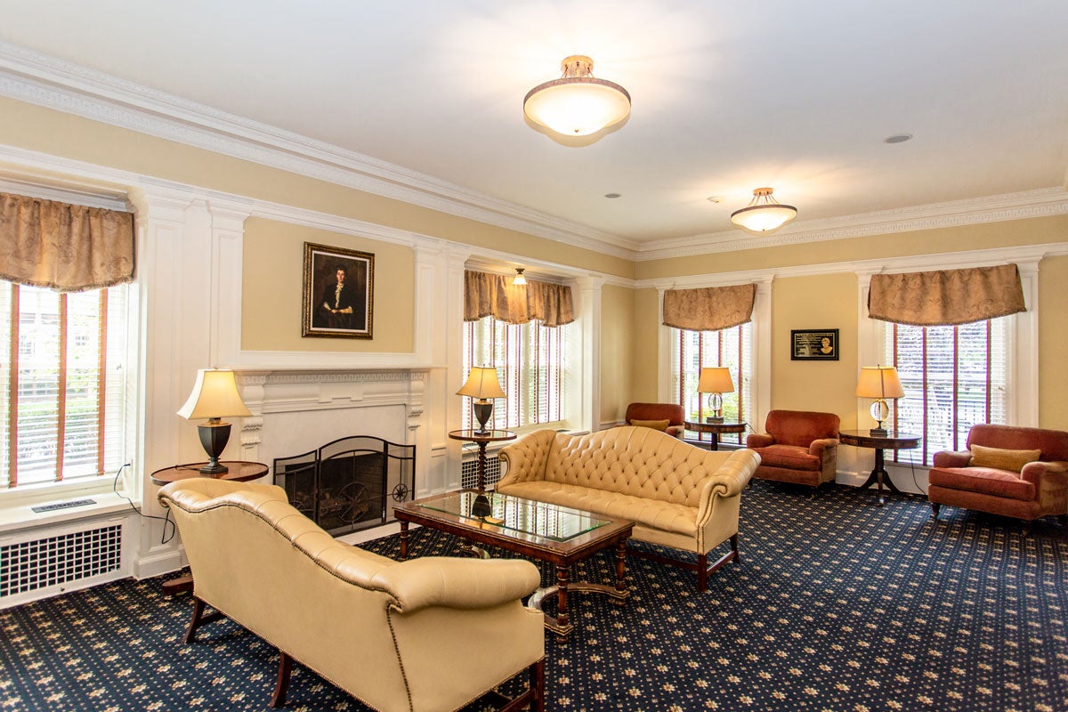 Couches seated in front of the fireplace in the living room at the The Linsalata Alumni Center