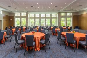 The Great Hall at the The Linsalata Alumni Center with tables set up in front of the large floor to ceiling windows 