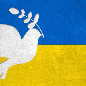 Image of flag of Ukraine with dove in front of it