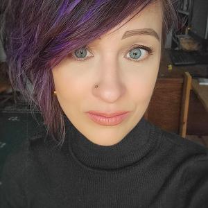 Headshot of woman wearing dark turtleneck