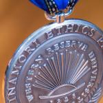Close-up of silver Inamori medal with gold background
