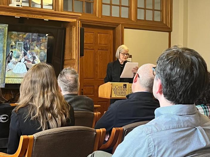 A CWRU faculty member speaking to an audience at a podium