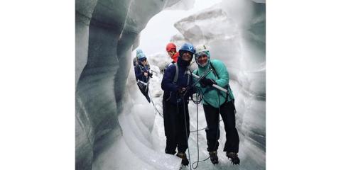 A group of people hiking in an ice cavern