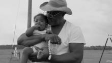 black and white picture of a man and baby