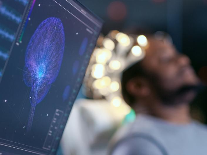 Close up of a Monitor Showing EEG Reading and Graphical Brain Model