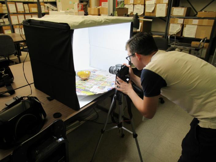 Student photographing a bowl in a photo studio setup