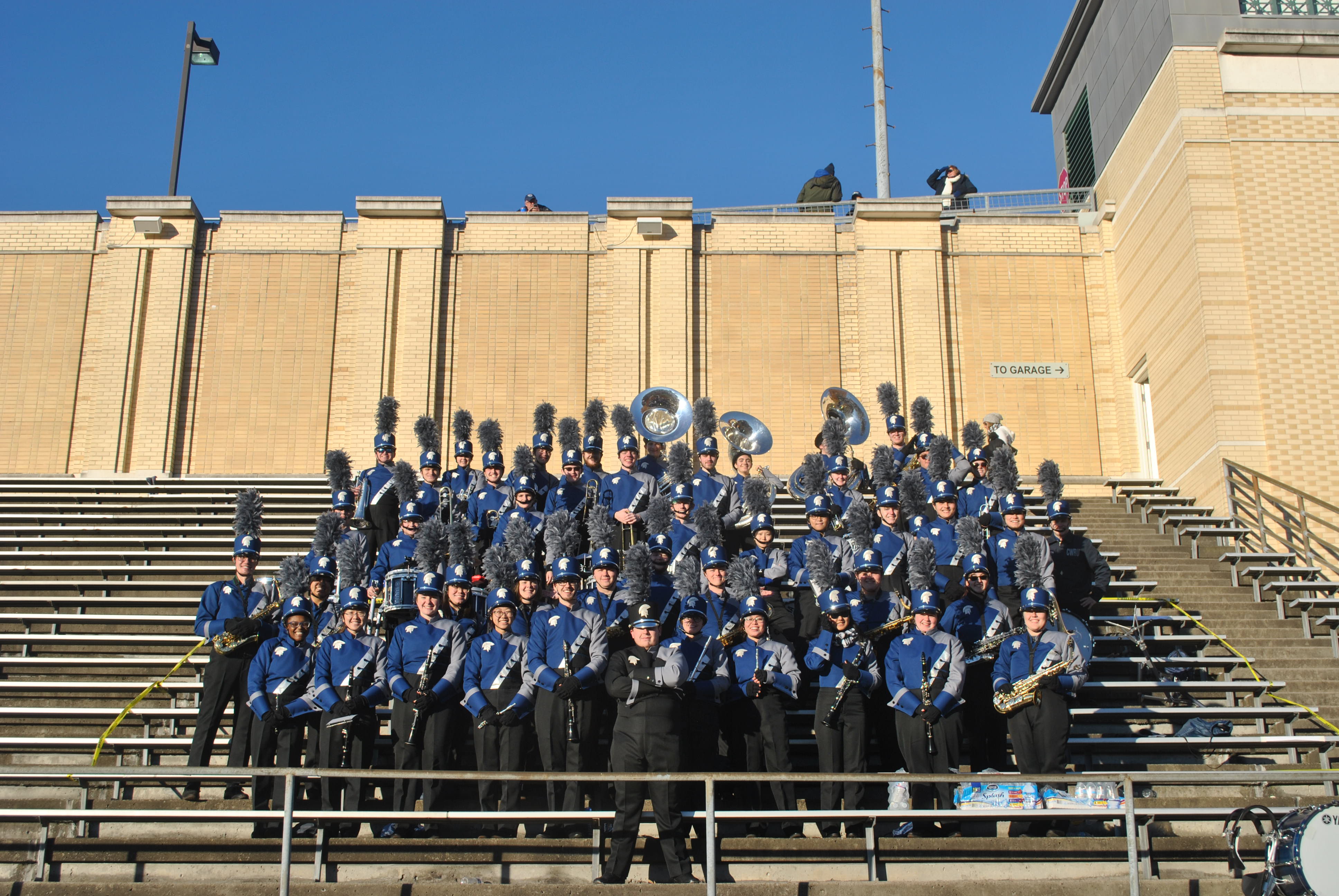 Spartan Marching Band in uniform in the stands at the football stadium.