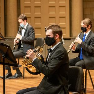 Symphonic Wind musicians play masked at the Maltz Performing Arts Center