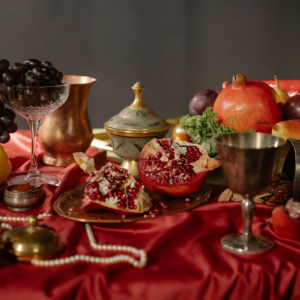 A feast of food on a table with dark red linens