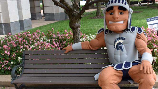 Spartie mascot sitting on a bench.